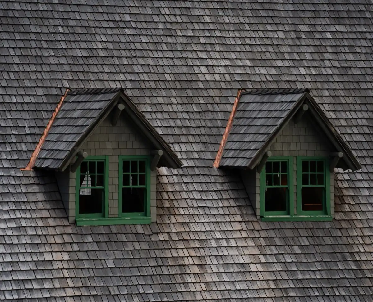 Dormers on a shingle roof in Erie, PA, where step flashing and kickout flashing carry water past the walls